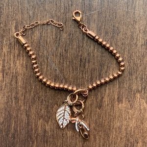 FOSSIL Charm Bracelet copper toned with 2 charms.